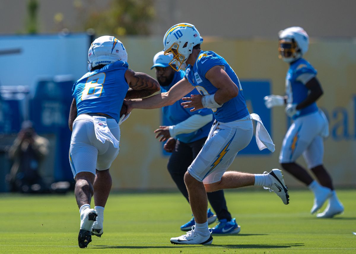 Los Angeles Chargers' quarterback, Justin Herbert 10, hands the football off to rookie Omarion Hampton 8, during training camp July 17, 2025 at The Bolt training facility in El Segundo, CA.
