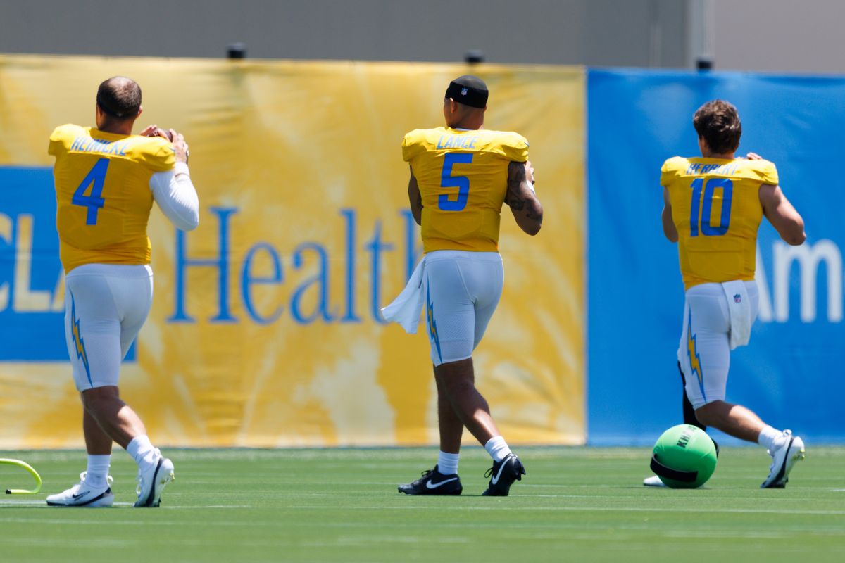 Trey Lance #5 of the Los Angeles Chargers warms up with Taylor Heinicke #4 of the Los Angeles Chargers and Justin Herbert #10 of the Los Angeles Chargers during training camp at The Bolt on July 24, 2025 in El Segundo, California. Trey Lance #5 of the Los Angeles Chargers warms up with Taylor Heinicke #4 of the Los Angeles Chargers and Justin Herbert #10 of the Los Angeles Chargers during training camp at The Bolt on July 24, 2025 in El Segundo, California.