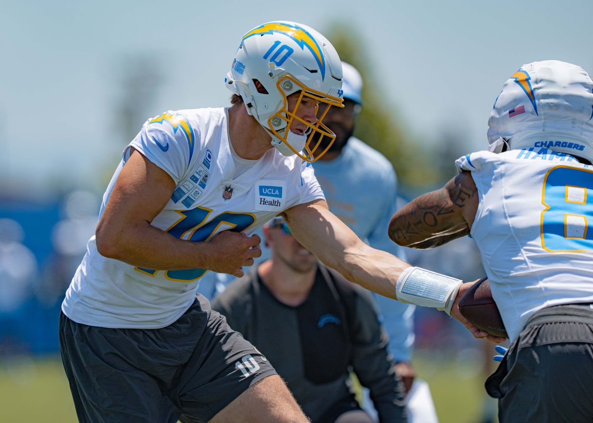 Los Angeles Chargers' quarterback, Justin Herbert 10, practices handing the ball off to running back Omarion Hampton 8, during training camp on July 29, 2025 at the Bolt in El Segundo, CA.