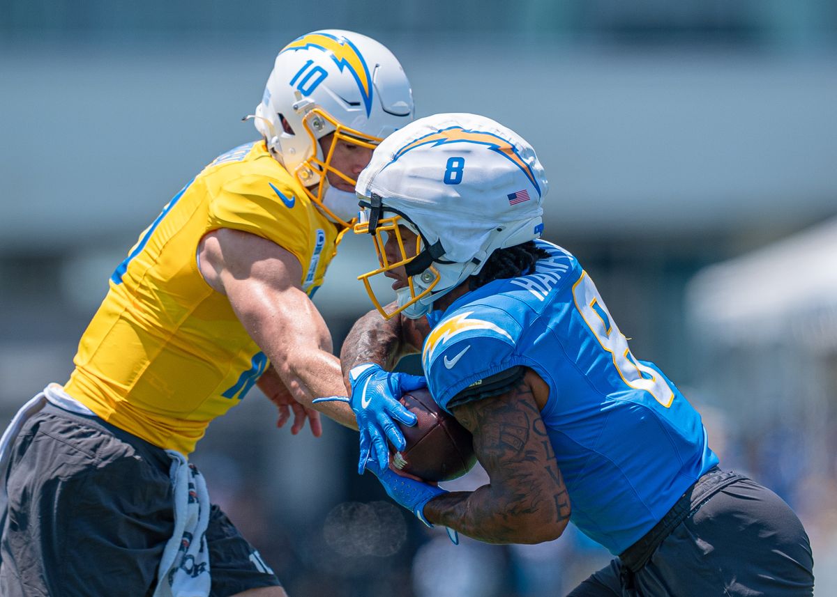 Los Angeles Chargers' running back, Omarion Hampton 8, receives a hand-off from quarterback Justin Herbert (10) during practice at the Chargers' NFL training camp on Sunday, August 3, 2025 at The Bolt in El Segundo, CA. Los Angeles Chargers' running back, Omarion Hampton 8, receives a hand-off from quarterback Justin Herbert (10) during practice at the Chargers' NFL training camp on Sunday, August 3, 2025 at The Bolt in El Segundo, CA.