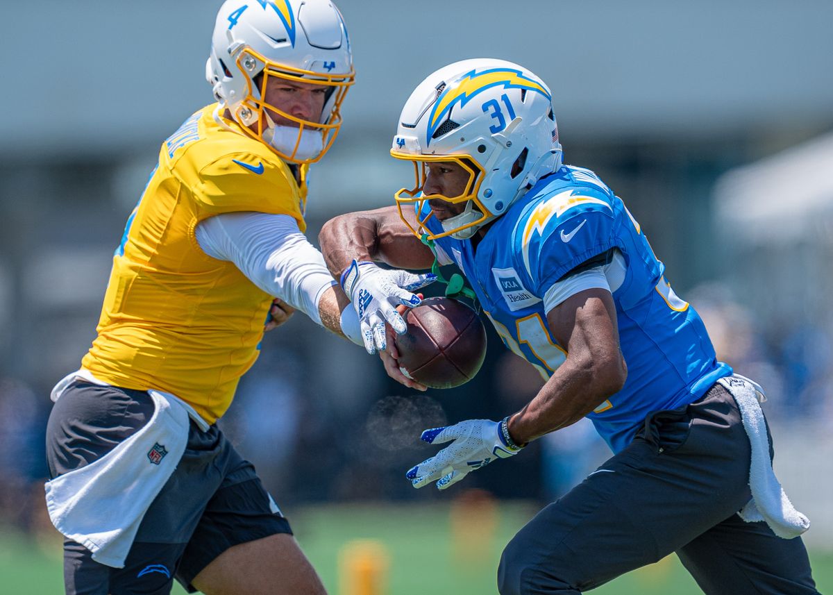 Los Angeles Chargers' running back, Nyheim Miller-Hines 31, receives a hand-off from quarterback Taylor Heinicke (4) during practice at the Chargers' NFL training camp on Sunday, August 3, 2025 at The Bolt in El Segundo, CA. Los Angeles Chargers' running back, Nyheim Miller-Hines 31, receives a hand-off from quarterback Taylor Heinicke (4) during practice at the Chargers' NFL training camp on Sunday, August 3, 2025 at The Bolt in El Segundo, CA.