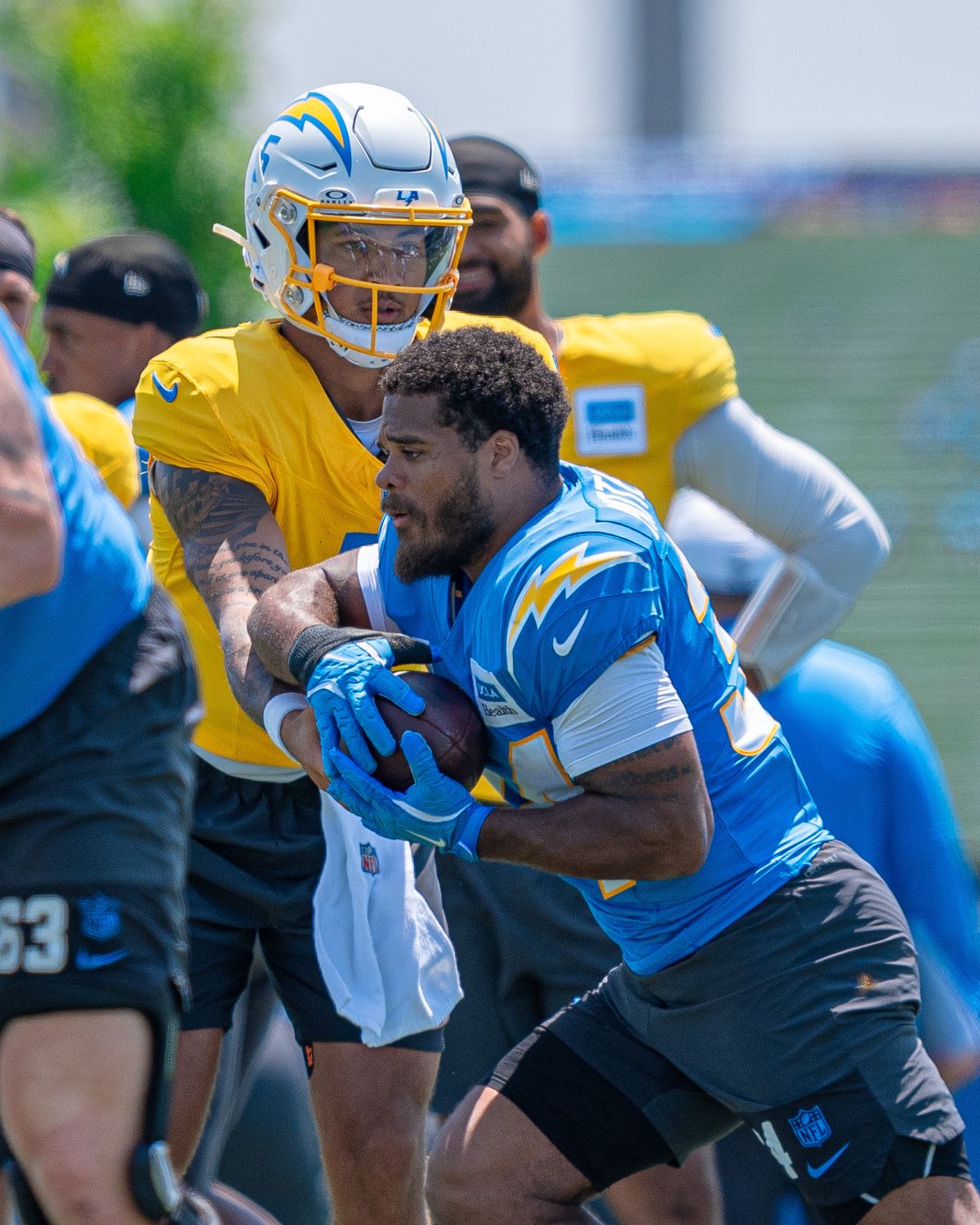 Los Angeles Chargers' quarterback, Trey Lance 5, hands the ball off to running back Jaret Patterson (34) during practice at the Chargers' NFL training camp on Sunday, August 3, 2025 at The Bolt in El Segundo, CA. Los Angeles Chargers' quarterback, Trey Lance 5, hands the ball off to running back Jaret Patterson (34) during practice at the Chargers' NFL training camp on Sunday, August 3, 2025 at The Bolt in El Segundo, CA.