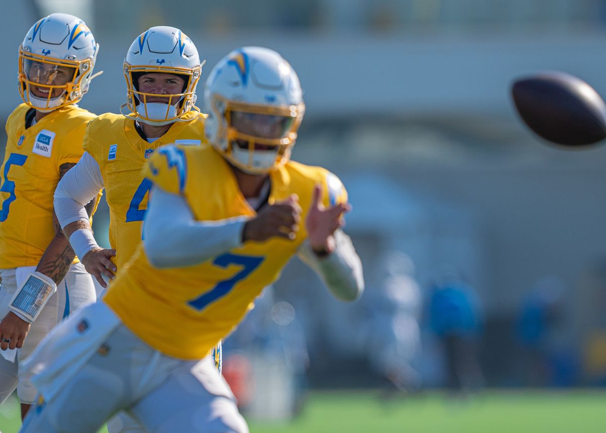 Los Angeles Chargers' quarterbacks, Taylor Heinicke (4) and Trey Lance (5) observe DJ Uiagalelei (7) as Uiagalelei tosses the ball during practice at The Bolt on Tuesday, August 5th, 2025 in El Segundo, CA.