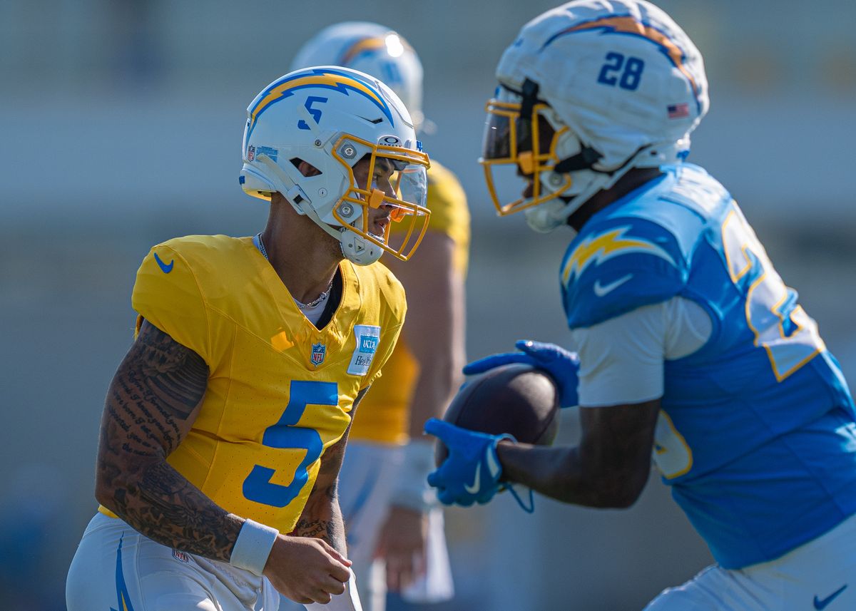 Los Angeles Chargers' quarterback, Trey Lance (5), looks back for feedback as running back Hassan Haskins (28) runs past during practice at The Bolt on Tuesday, August 5th, 2025 in El Segundo, CA.