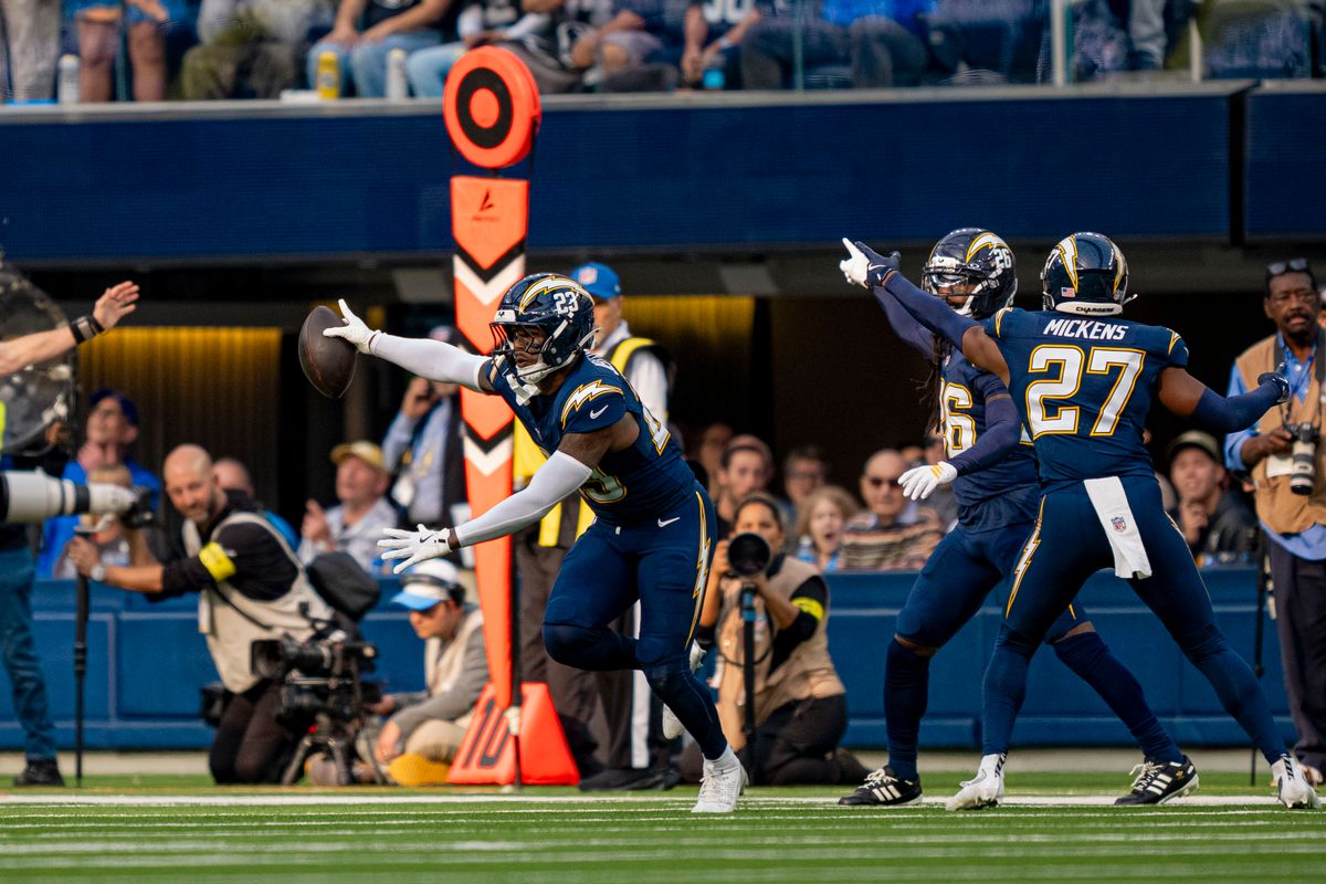Los Angeles Chargers safety, Tony Jefferson (23) intercepts a pass broken up by Donte Jackson (26) during an NFL football game against the Las Vegas Raiders on November 30, 2025 in Los Angeles, CA.
