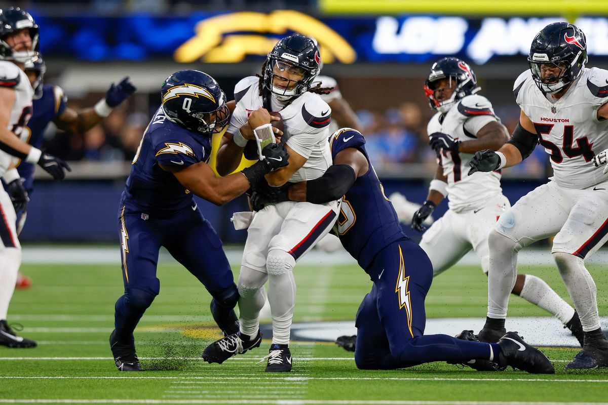 Houston Texans quarterback C.J. Stroud (7) gets sacked by Los Angeles Chargers linebacker Daiyan Henley (0) and Los Angeles Chargers linebacker Odafe Oweh (98) during a NFL game against the Houston Texans on December 027, 2025 at Sofi Stadium in Inglewood, CA.