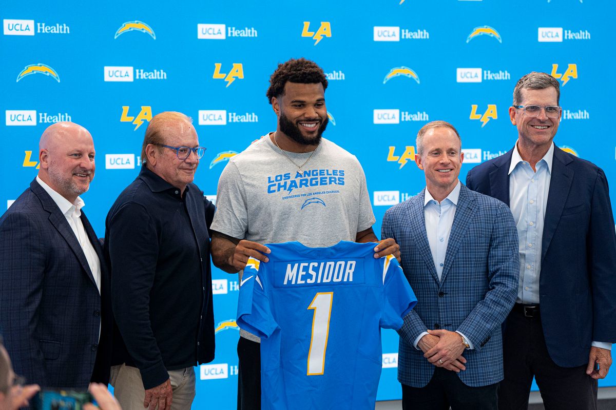 Los Angeles Chargers edge Akheem Mesidor takes photos with owners and coaches after his first presser after being drafted in the first round of the NFL Draft on April 24th, 2026 at The Bolt.