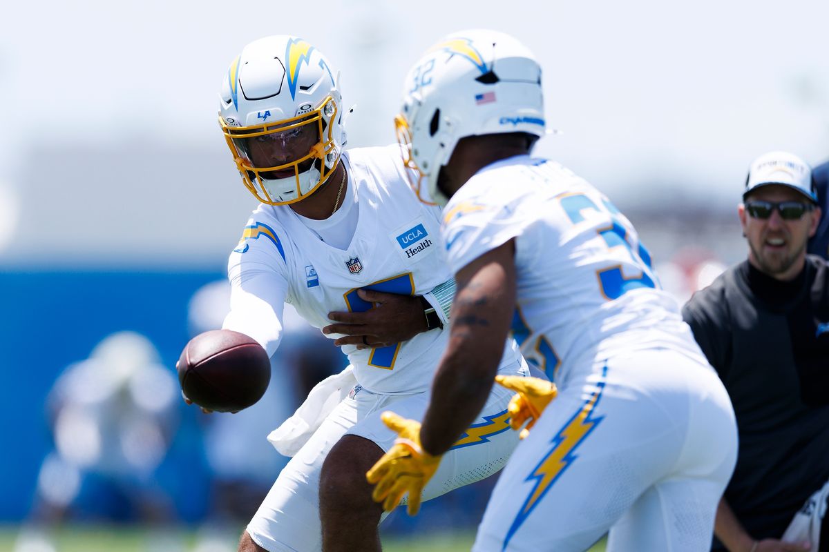 DJ Uiagalelei #7 of the Los Angeles Chargers hands off to Jaret Patterson #32 of the Los Angeles Chargers during organized team activities workout at The Bolt on May 27, 2026 in El Segundo, California. DJ Uiagalelei #7 of the Los Angeles Chargers hands off to Jaret Patterson #32 of the Los Angeles Chargers during organized team activities workout at The Bolt on May 27, 2026 in El Segundo, California.