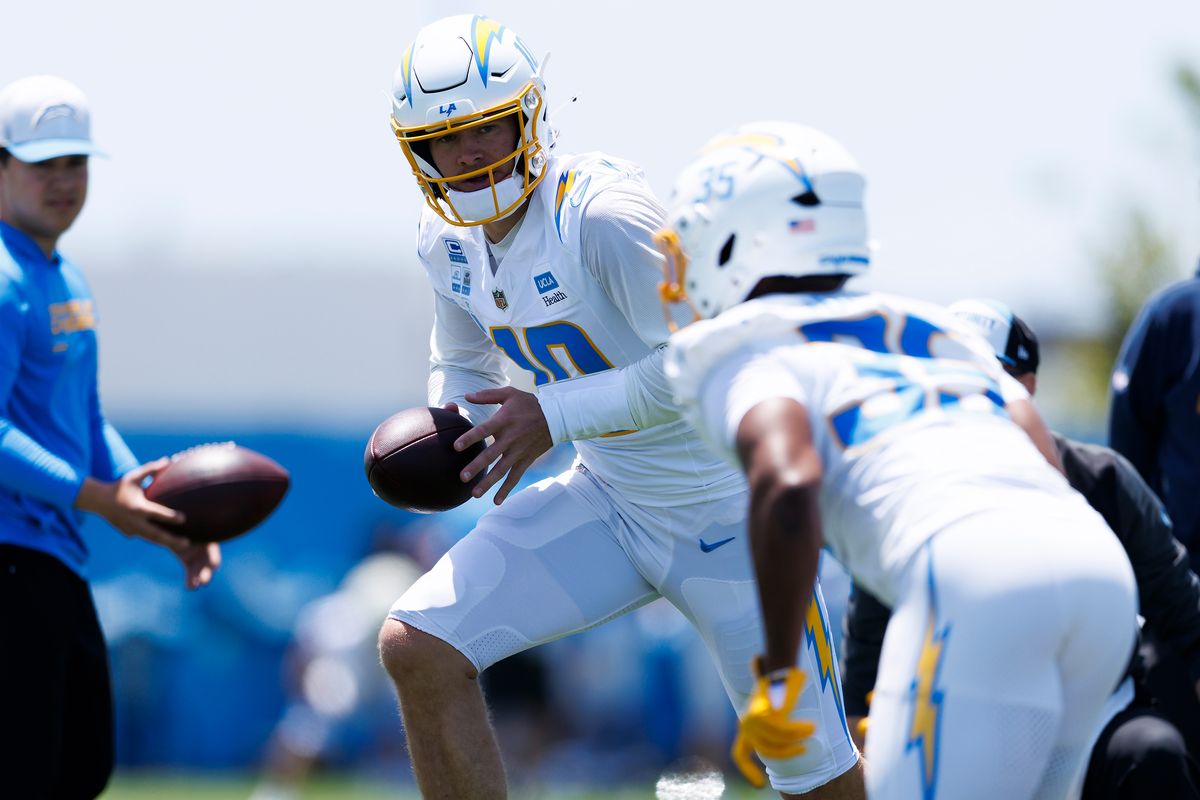 Justin Herbert #10 of the Los Angeles Chargers hands off to Amar Johnson #35 of the Los Angeles Chargers during organized team activities workout at The Bolt on May 27, 2026 in El Segundo, California. Justin Herbert #10 of the Los Angeles Chargers hands off to Amar Johnson #35 of the Los Angeles Chargers during organized team activities workout at The Bolt on May 27, 2026 in El Segundo, California.