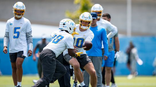 Los Angeles Chargers quarterback Justin Herbert (10) hands the ball off to running back Kimani Vidal (28) during Chargers organized team activities at the Bolt on Tuesday, June 2nd in El Segundo, CA.