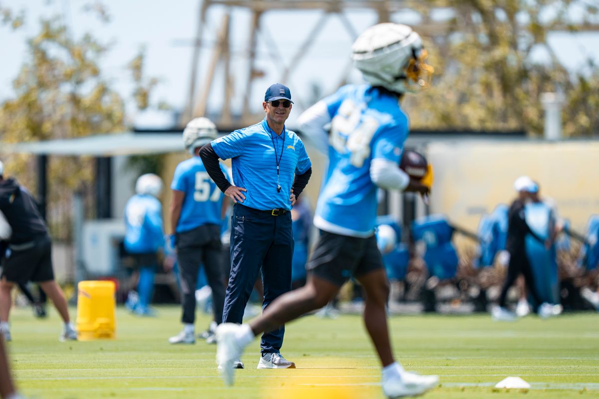 Los Angeles Chargers head coach Jim Harbaugh watches cornerback Rodney Shelley (24) complete interception drills during Chargers organized team activities at the Bolt on Tuesday, June 2nd in El Segundo, CA. Los Angeles Chargers head coach Jim Harbaugh watches cornerback Rodney Shelley (24) complete interception drills during Chargers organized team activities at the Bolt on Tuesday, June 2nd in El Segundo, CA.