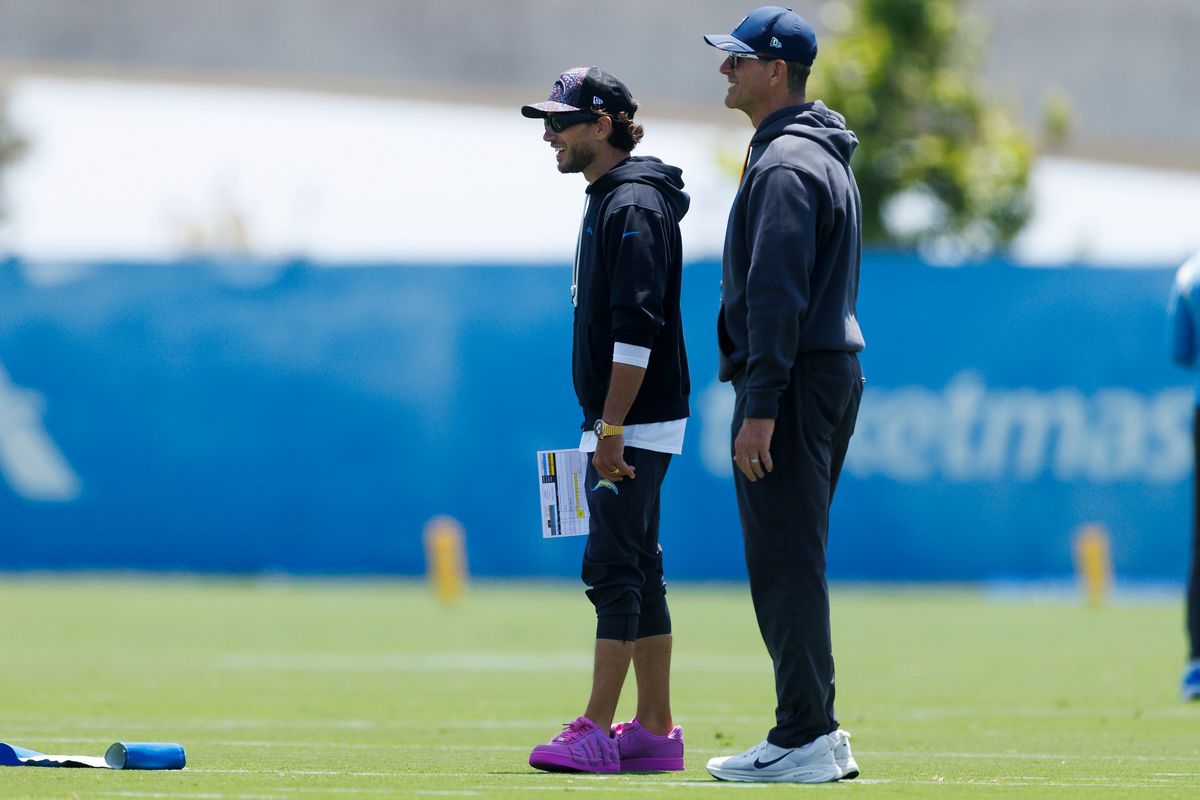 Mike McDaniels and Jim Harbaugh of the Los Angeles Chargers watch during offseason organized team activities at The Bolt on May 26, 2026 in El Segundo, California. Mike McDaniels and Jim Harbaugh of the Los Angeles Chargers watch during offseason organized team activities at The Bolt on May 26, 2026 in El Segundo, California.