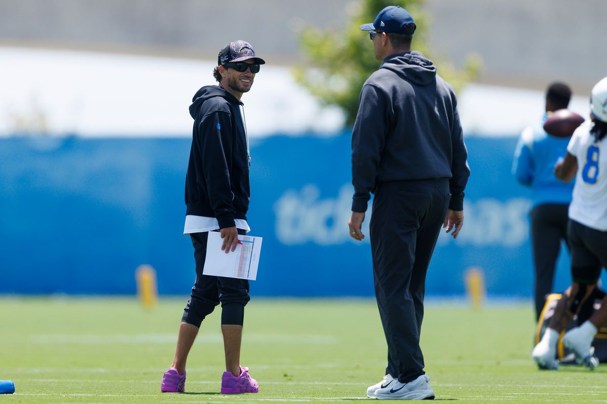 Mike McDaniels and Jim Harbaugh of the Los Angeles Chargers talk during offseason organized team activities at The Bolt on May 26, 2026 in El Segundo, California. Mike McDaniels and Jim Harbaugh of the Los Angeles Chargers talk during offseason organized team activities at The Bolt on May 26, 2026 in El Segundo, California.