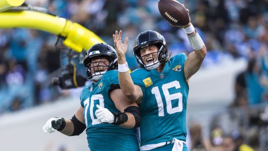 Nov 16, 2025; Jacksonville, Florida, USA; Jacksonville Jaguars quarterback Trevor Lawrence (16) celebrates with offensive tackle Cole Van Lanen (70) after rushing for a touchdown against the Los Angeles Chargers during the third quarter at EverBank Stadium.