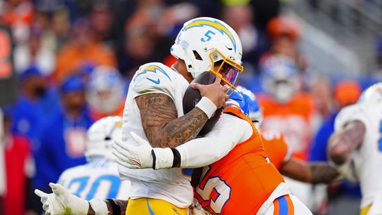 Jan 4, 2026; Denver, Colorado, USA; Denver Broncos linebacker Nik Bonitto (15) hits Los Angeles Chargers quarterback Trey Lance (5) during the third quarter at Empower Field at Mile High.