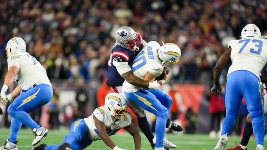Jan 11, 2026; Foxborough, MA, USA; Los Angeles Chargers quarterback Justin Herbert (10) is sacked by New England Patriots linebacker Anfernee Jennings (33) during the fourth quarter against the New England Patriotsin an AFC Wild Card Round game at Gillette Stadium.
