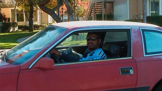 Bill Jackson sits in his car as his son Byron records. Bill Jackson sits in his car as his son Byron records.