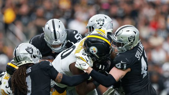 Las Vegas Raiders safety Tre'von Moehrig (7) and Las Vegas Raiders linebacker Robert Spillane (41) makes a tackle during a NFL football game against the Pittsburgh Steelers at Allegiant Stadium on October 29, 2024 in Las Vegas, Nevada. (Photo by Jordon Kelly/The Sporting Tribune)
