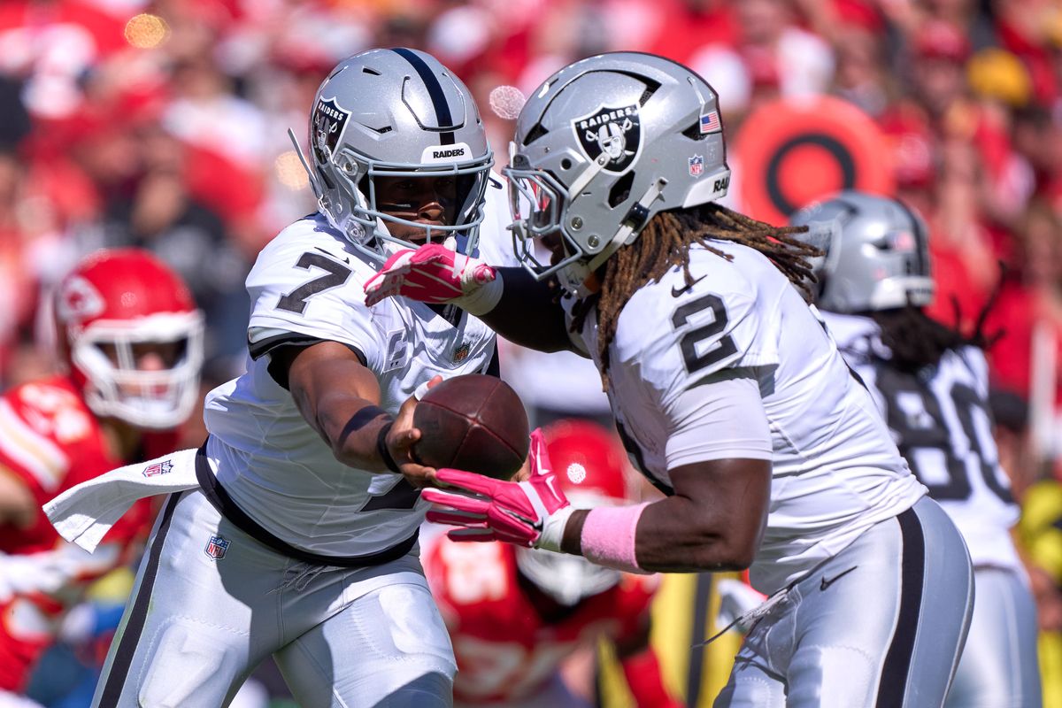 Las Vegas Raiders quarterback Geno Smith #7 hands the football to Las Vegas Raiders running back Ashton Jeanty #2 in the second half against the Kansas City Chiefs during an NFL game at Arrowhead Stadium on October 19, 2025 in Kansas City, Missouri. Las Vegas Raiders quarterback Geno Smith #7 hands the football to Las Vegas Raiders running back Ashton Jeanty #2 in the second half against the Kansas City Chiefs during an NFL game at Arrowhead Stadium on October 19, 2025 in Kansas City, Missouri.