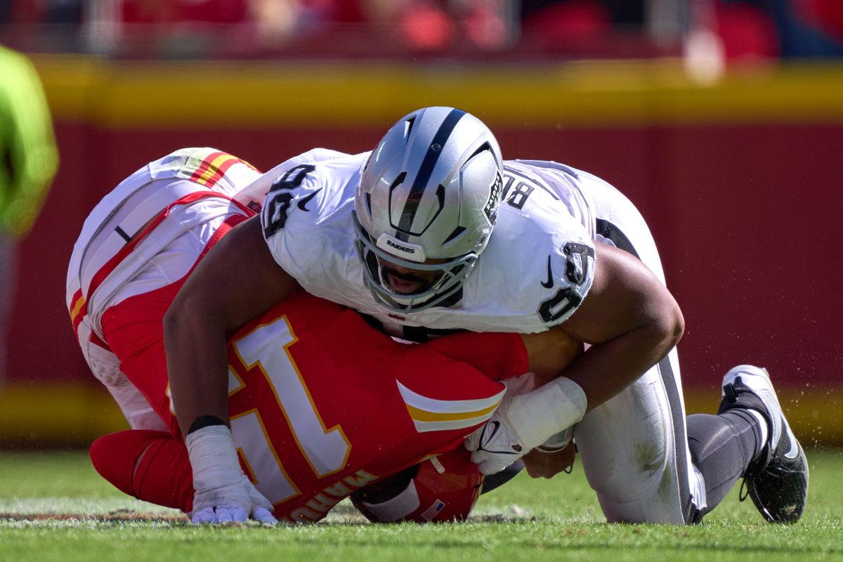 Las Vegas Raiders defensive tackle Thomas Booker #99 tackles Kansas City Chiefs quarterback Patrick Mahomes #15 in the first half against the Kansas City Chiefs during an NFL game at Arrowhead Stadium on October 19, 2025 in Kansas City, Missouri. Las Vegas Raiders defensive tackle Thomas Booker #99 tackles Kansas City Chiefs quarterback Patrick Mahomes #15 in the first half against the Kansas City Chiefs during an NFL game at Arrowhead Stadium on October 19, 2025 in Kansas City, Missouri.