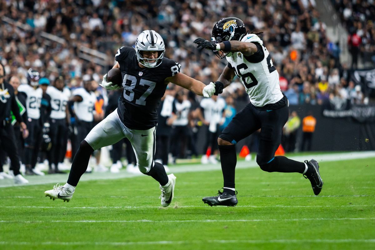 Las Vegas Raiders tight-end Michael Mayer (87) stiff arms Jacksonville Jaguars safety Antonio Johnson (26) during a NFL game between the Las Vegas Raiders and the Jacksonville Jaguars, Sunday November 2, 2025 in Las Vegas, Nev.