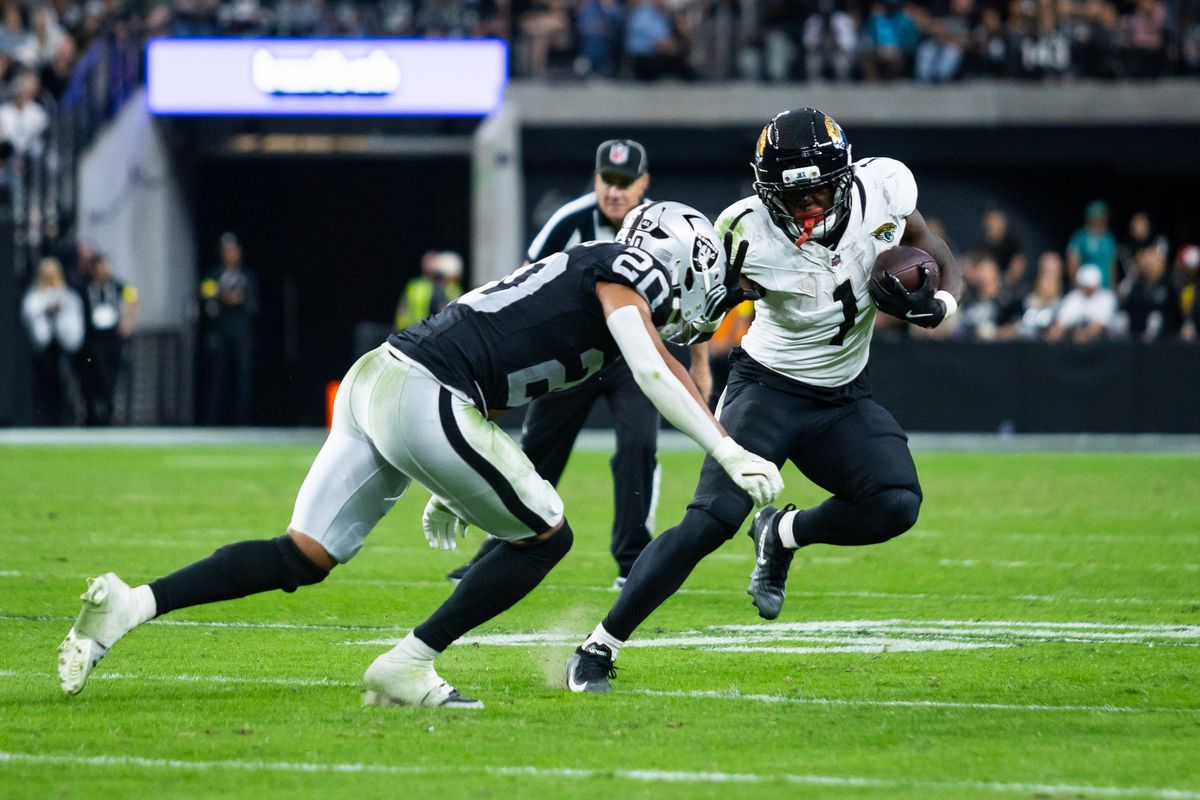  Jacksonville Jaguars running back Travis Etienne Jr. (1) looks to stiff arm Las Vegas Raiders safety Isaiah Pola-Mao (20) during a NFL game between the Las Vegas Raiders and the Jacksonville Jaguars, Sunday November 2, 2025 in Las Vegas, Nev.