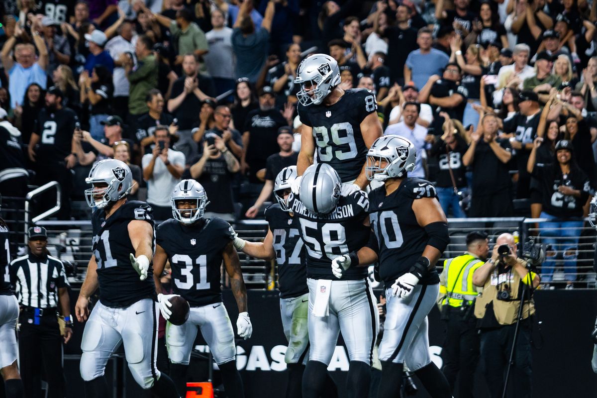 Las Vegas Raiders center Jackson Powers-Johnson (58) lifts tight-end Brock Bowers (89) after Bowers scores a touchdown during a NFL game between the Las Vegas Raiders and the Jacksonville Jaguars, Sunday November 2, 2025 in Las Vegas, Nev.