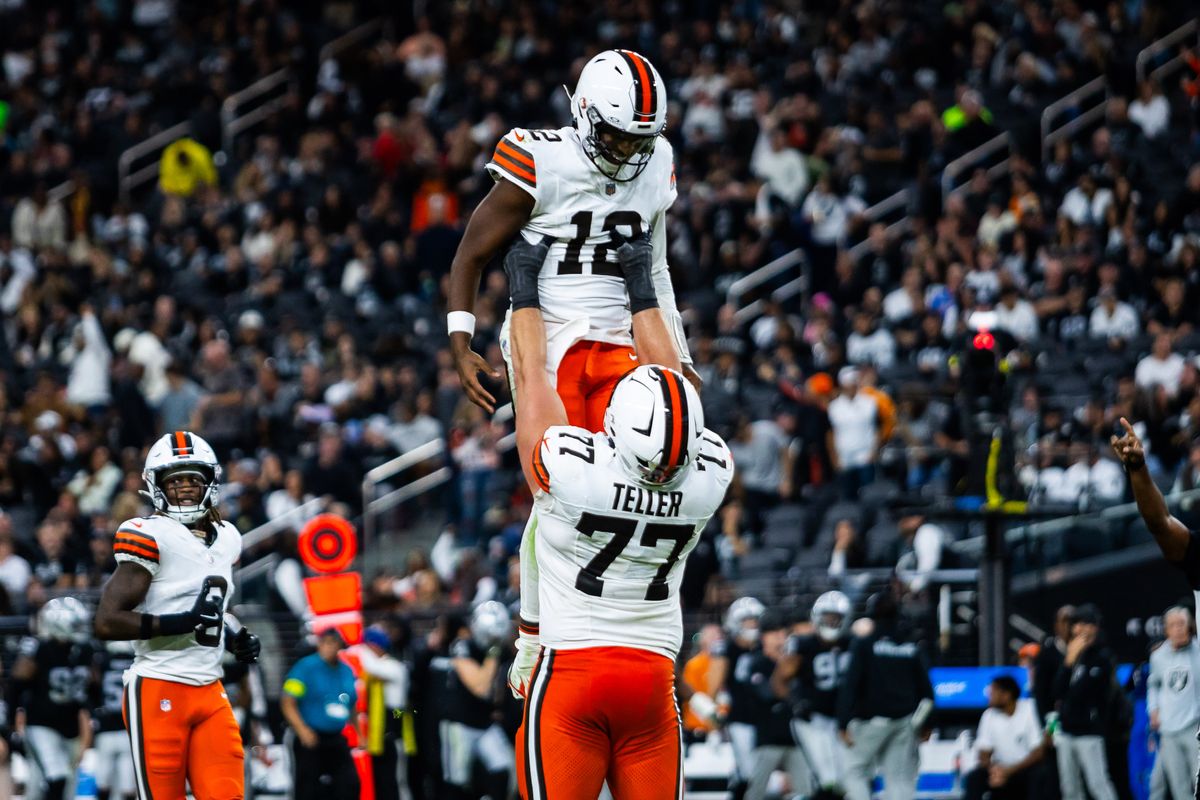  Cleveland Browns guard Wyatt Teller (77) carries quarterback Shadeur Sanders (12) after Sanders throws for his first touchdown during a NFL game between the Las Vegas Raiders and the Cleveland Browns, Sunday November 23, 2025 in Las Vegas, Nev.