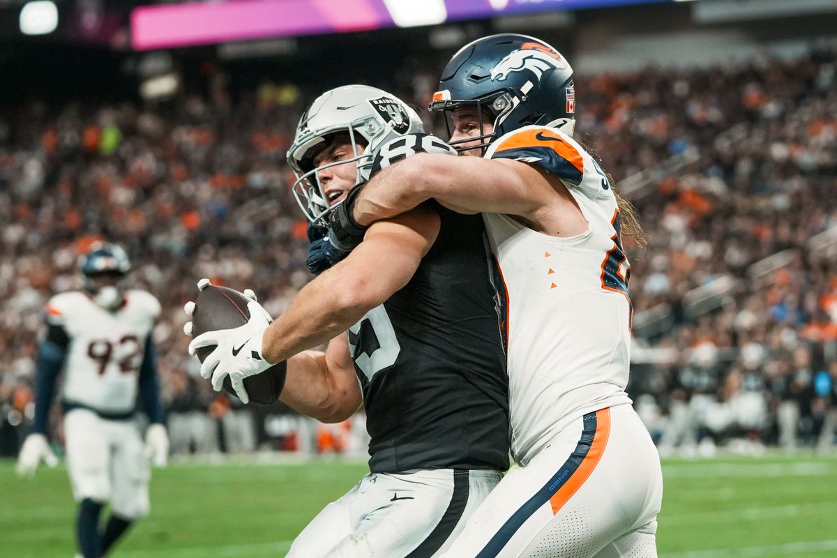 Raiders tight end Brock Bowers (89) is tackled out of bounds by Broncos line backer Alex Singleton (49) during third quarter of NFL game against the Broncos Sunday, Dec. 7, 2025 at Allegiant Stadium in Las Vegas.