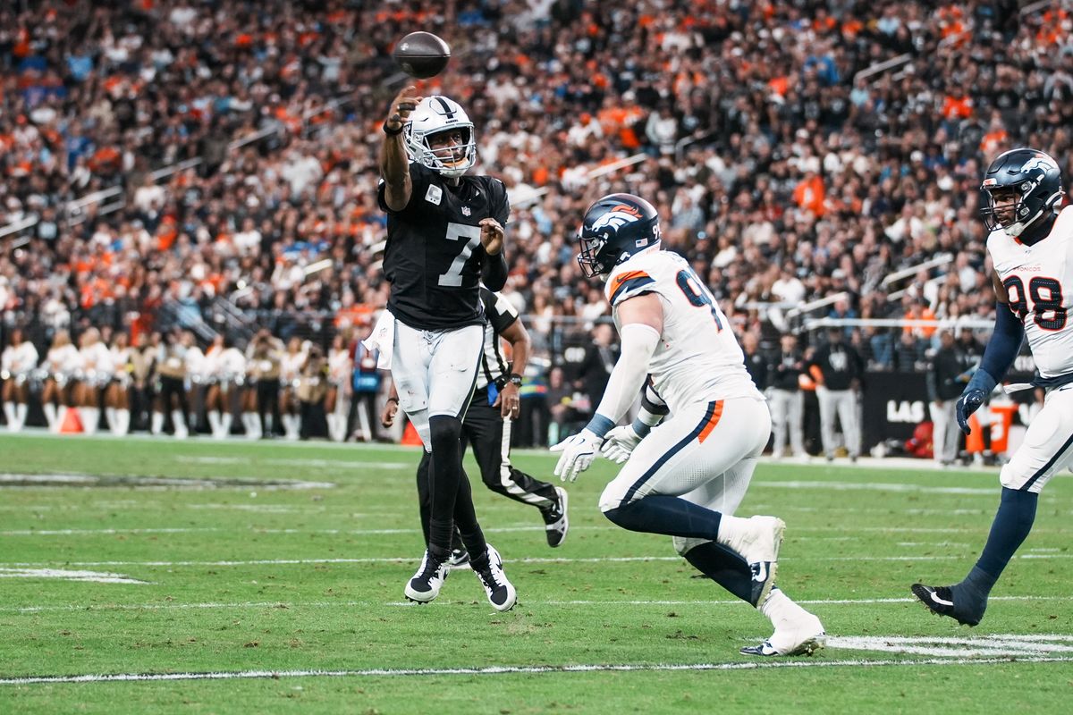 Raiders quarterback Geno Smith (7) passes the ball over Broncos defensive tackle Malcolm Roach (97)  during third quarter of NFL game against the Broncos on Sunday, Dec. 7, 2025 at Allegiant Stadium in Las Vegas.