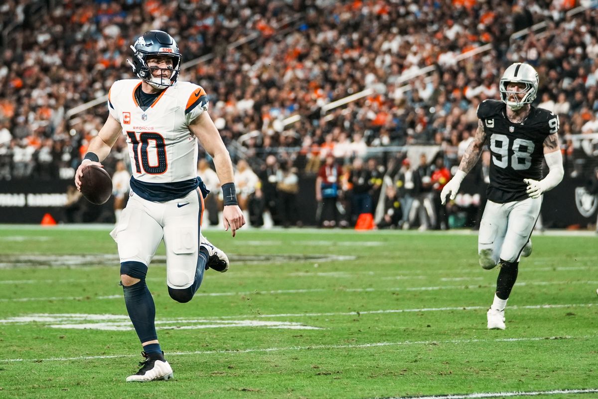 Broncos quarterback Bo Nic (10) takes the ball downfield trailed by Raiders defensive end Max Crosby (98) during fourth quarter  of NFL game against the Raiders on Sunday, Dec. 7, 2025 at Allegiant Stadium in Las Vegas.