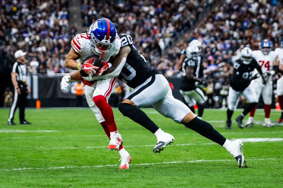 New York Giants wide receiver Wan’Dale Robinson (17) is tackled by Las Vegas Raiders safety Isaiah Pola-Mao (20) after making a reception during a NFL game between the Las Vegas Raiders and the New York Giants, Sunday December 28, 2025 in Las Vegas, Nev.