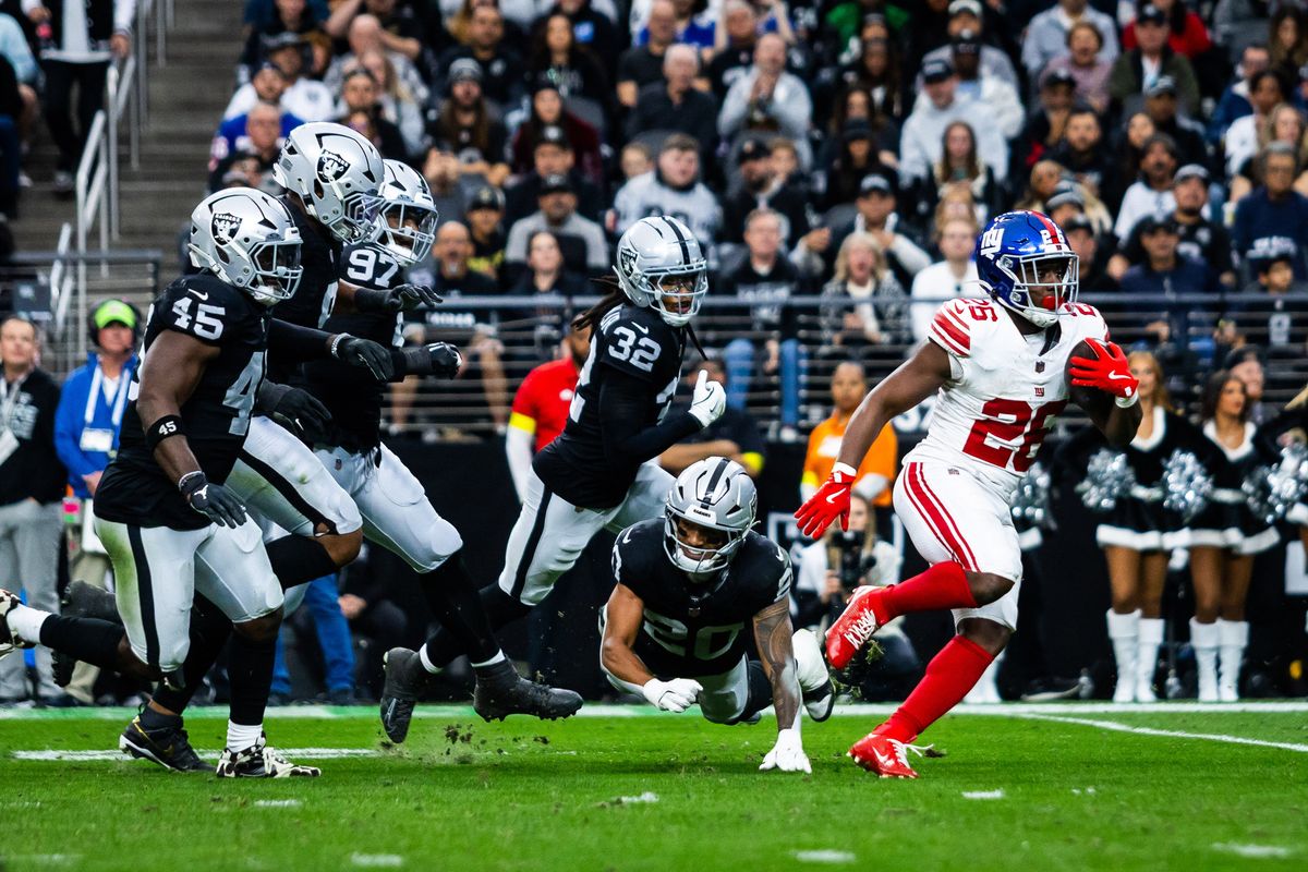 New York Giants running back Devin Singletary (26) runs past the Las Vegas Raiders defense during a NFL game between the Las Vegas Raiders and the New York Giants, Sunday December 28, 2025 in Las Vegas, Nev.