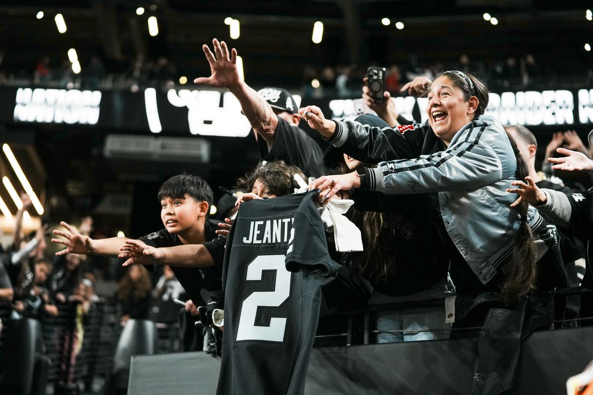 Raiders fans reach to running back Ashton Jeanty as he leaves the field after defeating the Chiefs in  NFL game against Chiefs on Sunday, January 4, 2026 at Allegiant Stadium in Las Vegas.