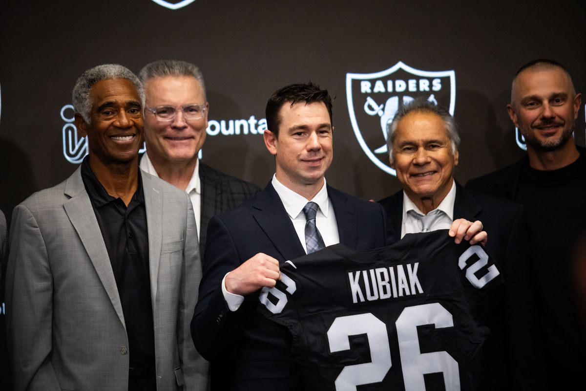 Las Vegas Raiders newly hired head coach Klint Kubiak holds a Raiders jersey and poses for a photo after a press conference, Tuesday February 10, 2026 in Henderson, Nev. 