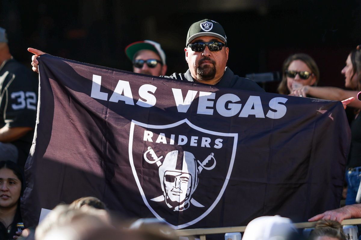 Fan holds up a  Las Vegas Raiders flag at the Raiders 2026 Draft Party at Palms Casino Resort, Thursday April 23, 2026 in Las Vegas, Nev. 