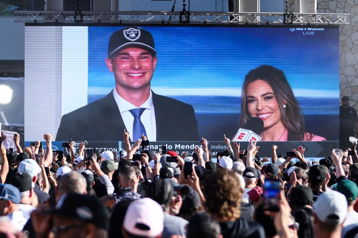 Fans cheer and raise their hands as Las Vegas Raiders No. 1 overall pick Fernando Mendoza is shown on the big screen during the Raiders 2026 Draft Party at Palms Casino Resort, Thursday April 23, 2026 in Las Vegas, Nev. 