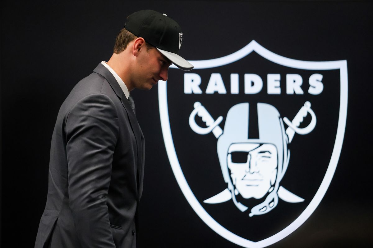 Las Vegas Raiders quarterback Fernando Mendoza walks past the Raiders’ logo after a press conference, Friday April 24, 2026 in Henderson, Nev.