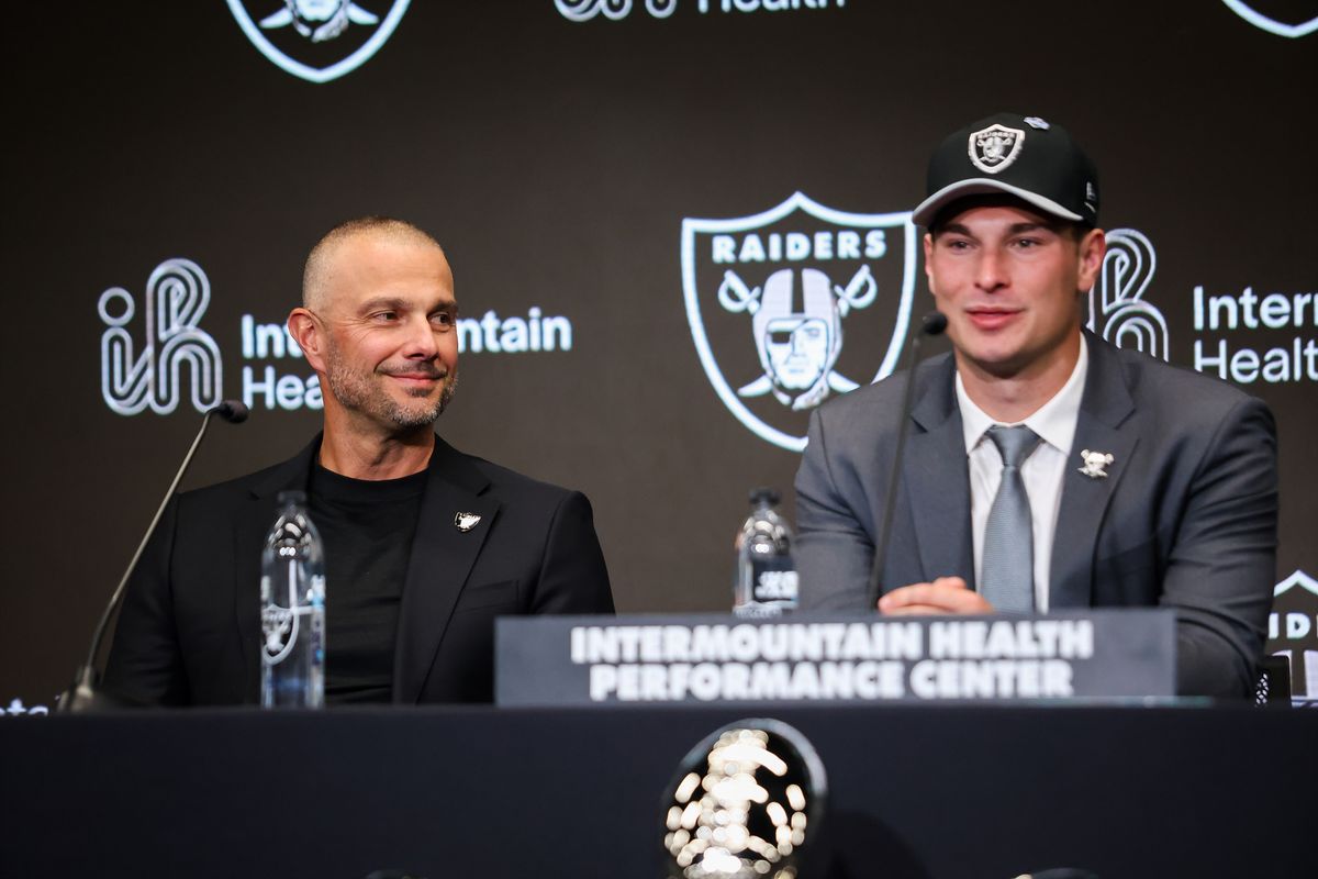 Las Vegas Raiders general manager John Spytek smiles as quarterback Fernando Mendoza answers a question during a press conference, Friday April 24, 2026 in Henderson, Nev.