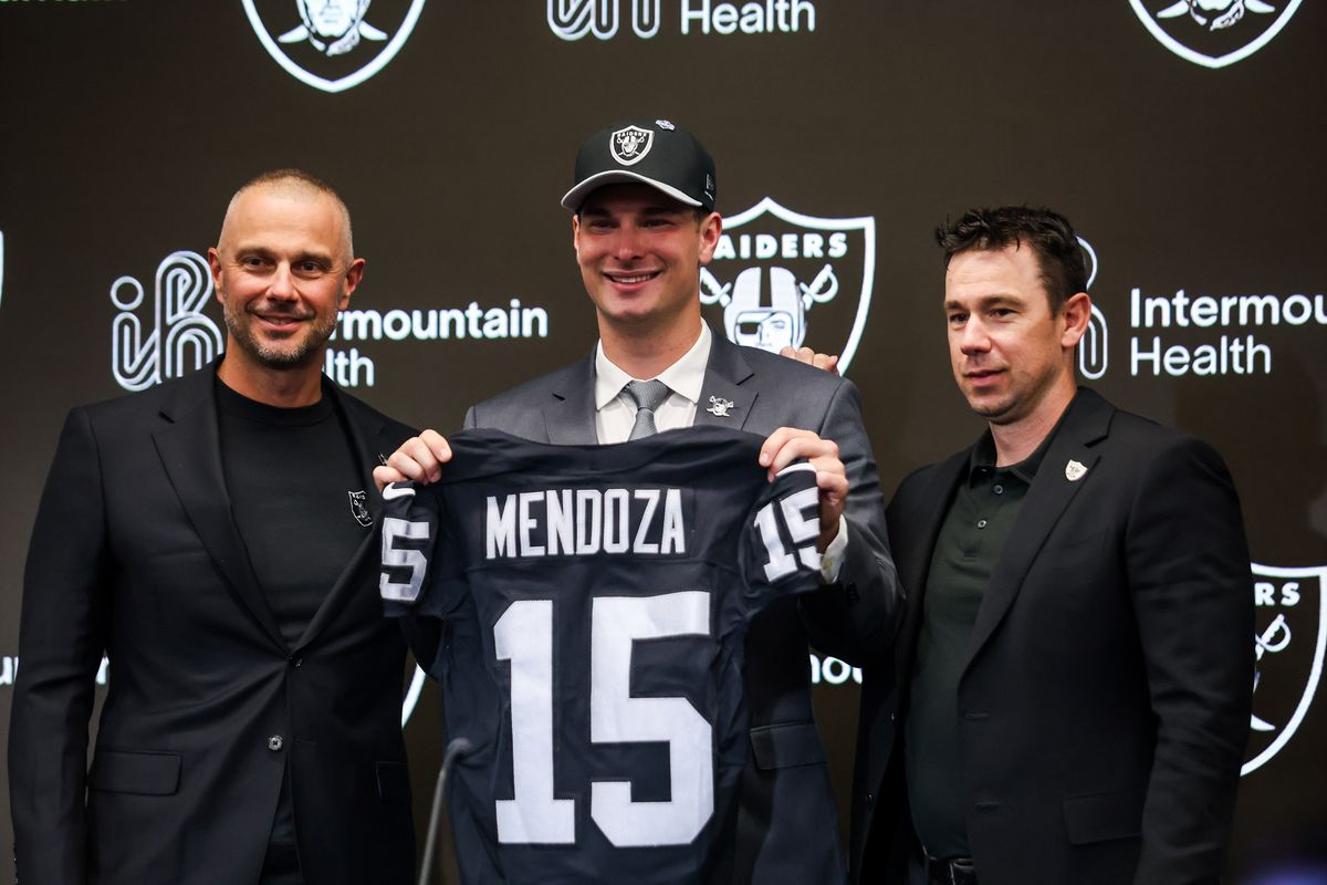 Las Vegas Raiders general manager John Spytek, quarterback Fernando Mendoza, and head coach Klint Kubiak pose for a photo after a press conference, Friday April 24, 2026 in Henderson, Nev.