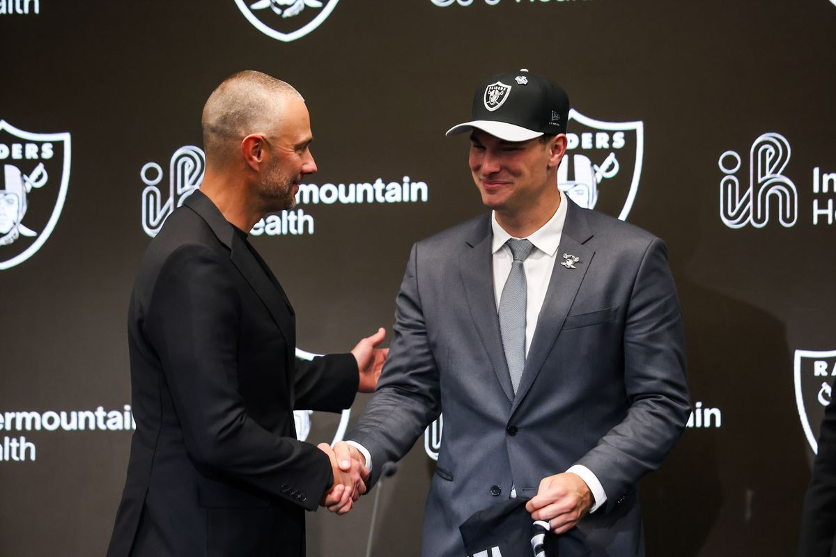Las Vegas Raiders general manager John Spytek shakes the hand of quarterback Fernando Mendoza after a press conference, Friday April 24, 2026 in Henderson, Nev.