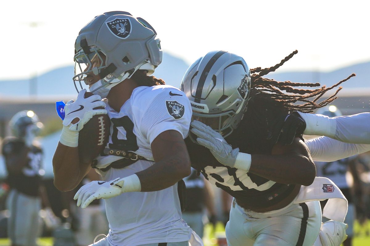 Las Vegas Raiders safety Devyn Perkins (49) runs with the ball past tight end Ian Thomas (80) during Raiders Training Camp at Intermountain Health Performance Center, Saturday Aug. 8, 2026 in Henderson, Nev. Las Vegas Raiders safety Devyn Perkins (49) runs with the ball past tight end Ian Thomas (80) during Raiders Training Camp at Intermountain Health Performance Center, Saturday Aug. 8, 2026 in Henderson, Nev.