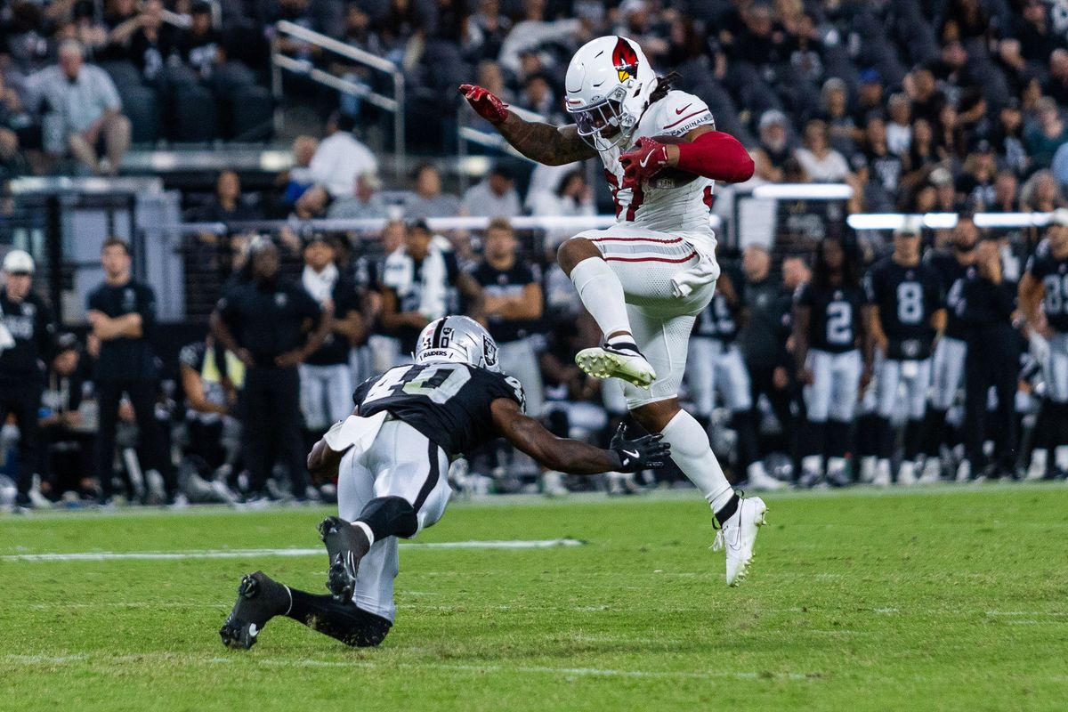 Arizona Cardinals running back Corey Kiner (37) hurdles over a Las Vegas Raiders safety Devin Lafayette (40) during a NFL Preseason game between the Las Vegas Raiders and the Arizona Cardinals at Allegiant Stadium, Thursday August 13, 2026 in Las Vegas, Nev. Arizona Cardinals running back Corey Kiner (37) hurdles over a Las Vegas Raiders safety Devin Lafayette (40) during a NFL Preseason game between the Las Vegas Raiders and the Arizona Cardinals at Allegiant Stadium, Thursday August 13, 2026 in Las Vegas, Nev.
