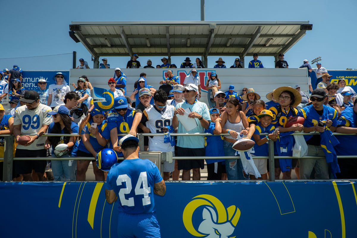Blake Corum #24 of the Los Angeles Rams signs autographs during Rams training camp at Loyola Marymount University on Sunday, August 2nd in Westchester, CA.