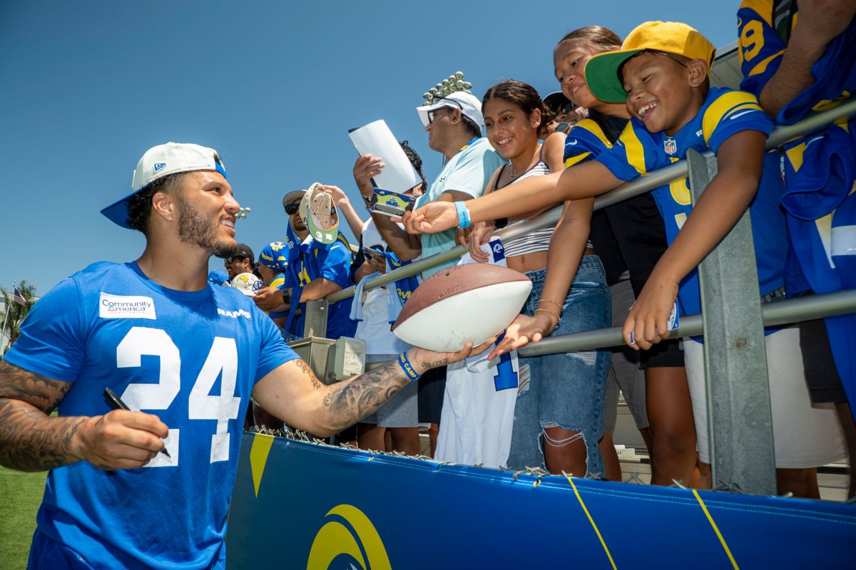 Blake Corum #24 of the Los Angeles Rams signs autographs during Rams training camp at Loyola Marymount University on Sunday, August 2nd in Westchester, CA.