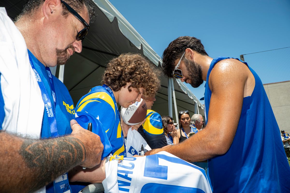 Puka Nacua #12 of the Los Angeles Rams signs autographs during Rams training camp at Loyola Marymount University on Sunday, August 2nd in Westchester, CA.