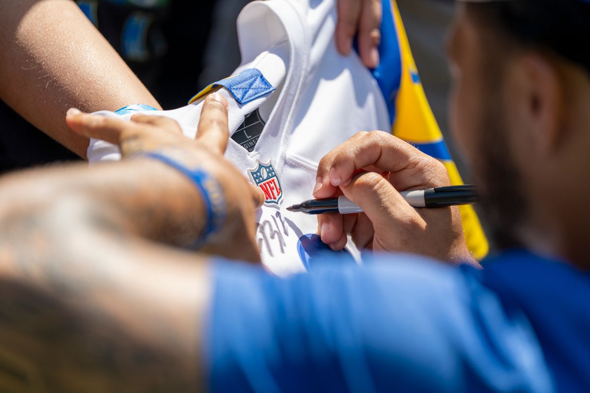 Blake Corum #24  of the Los Angeles Rams signing autographs during Rams training camp at Loyola Marymount University on Sunday, August 2nd in Westchester, CA.