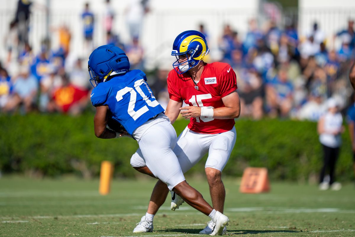 Ty Simpson #15 of the Los Angeles Rams handing the ball off to Ronnie Rivers #20 during Rams training camp at Loyola Marymount University on Wednesday, August 5th in Westchester, CA. Ty Simpson #15 of the Los Angeles Rams handing the ball off to Ronnie Rivers #20 during Rams training camp at Loyola Marymount University on Wednesday, August 5th in Westchester, CA.