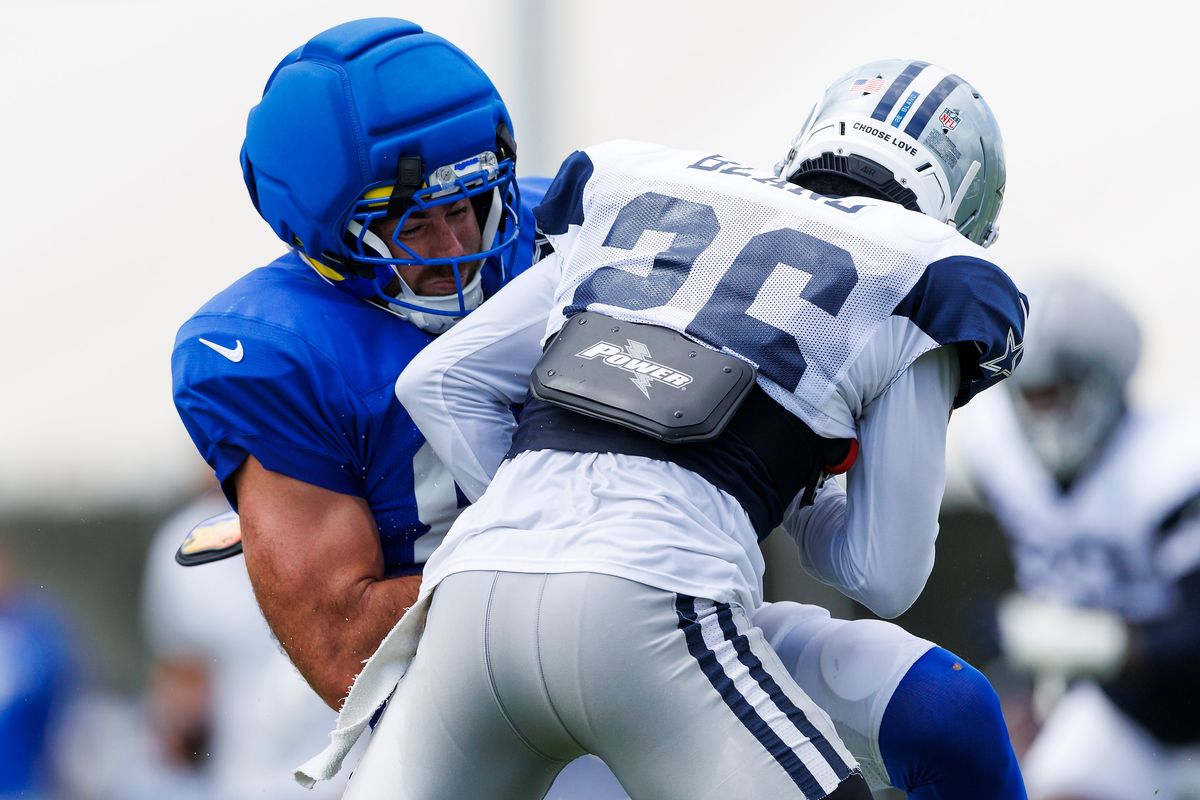 Daron Bland #26 of the Dallas Cowboys tackles Tyler Higbee #89 of the Los Angeles Rams during joint practice between the Dallas Cowboys and the Los Angeles Rams at Rams Village on August 11, 2026 in Woodland Hills, California. Daron Bland #26 of the Dallas Cowboys tackles Tyler Higbee #89 of the Los Angeles Rams during joint practice between the Dallas Cowboys and the Los Angeles Rams at Rams Village on August 11, 2026 in Woodland Hills, California.