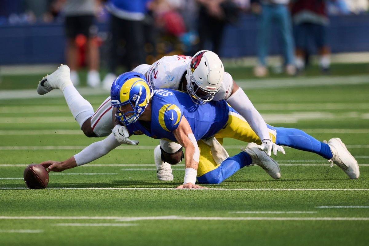 The Los Angeles Rams quarterback Matthew Stafford (9) reaches for a dropped ball during an NFL football game against The Arizona Cardinals on October 18th, 2026 at SoFi Stadium in Los Angeles, California. The Los Angeles Rams quarterback Matthew Stafford (9) reaches for a dropped ball during an NFL football game against The Arizona Cardinals on October 18th, 2026 at SoFi Stadium in Los Angeles, California.